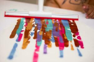 Wiped paint stripes, kid activity creative and idea, glass wiper wiped colorful paint on paper. photo