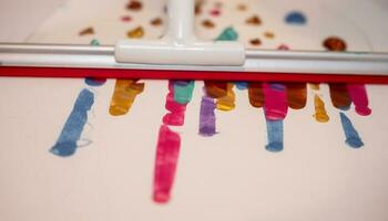 Wiped paint stripes, kid activity creative and idea, glass wiper wiped colorful paint on paper. photo