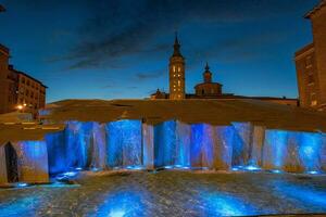 beautiful fountain in the old town of Zaragoza against a blue sky background photo