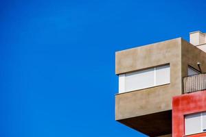 abstract colorful building in Alicante Spain over blue sky background photo