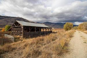 An old barn on a gravel trail in a valley photo