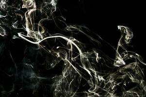 Smoke effect texture. Isolated background. Black and dark backdrop. Smokey fire and mistic effect. photo