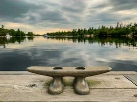 Dock cleat on a pier on a tranquil lake photo