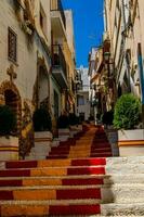antique staircase in Calpe, Spain in the old town painted red and yellow in the color of the country's flag photo