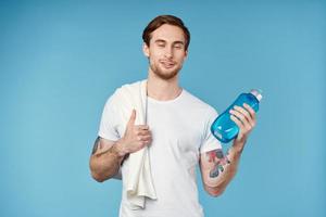 Cheerful man in white t-shirt workout water bottle energy photo