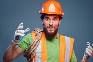 emotional man in work uniform safety professional blue background photo