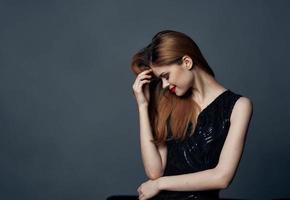 portrait of charming woman in black dress bright makeup red hair cropped view photo