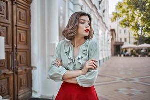cute blonde girl with red lips outdoors walk near the building photo