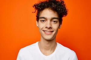 cute guy curly hair white t-shirt modern style orange background photo