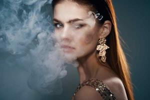woman golden dress smoke from the mouth decoration luxury photo