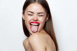 Brunette With bare shoulders, tongue shows closed eyes natural look photo