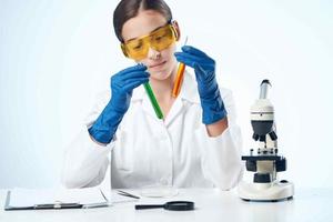 woman scientist laboratory analyzes diagnostics microscope technology photo