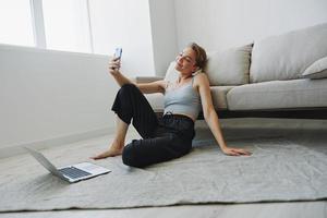 Woman blogger selfies on phone, selfies and online conversations for followers, teenager develops social media, freelancer from home photo