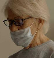 elderly woman wearing medical mask portrait close-up disease medicine infection covid passport photo