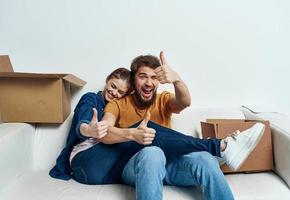 young couple in the room housewarming boxes with things moving emotions fun photo