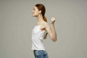 woman doing shoulder exercises health gray background photo