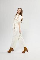 Charming Woman In Light Jumpsuit And Boots Fashion Style Side View photo
