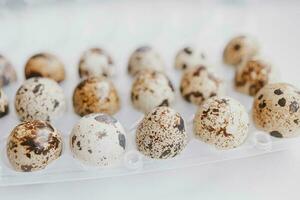quail eggs in a package on a bright background for Easter photo