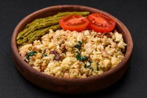 Delicious scramble with salmon, sun-dried tomatoes, spinach, spices and herbs photo