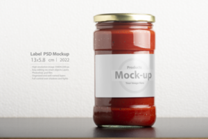 Tomato paste glassy jar with round cap on black table psd