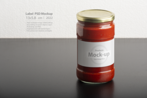 Tomato paste glassy jar with round cap on black table psd