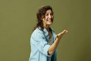 Irritated angry screaming curly female in jeans casual shirt quarrel with husband posing isolated on over olive green pastel background. Being Yourself. People Lifestyle emotions concept. Copy space photo
