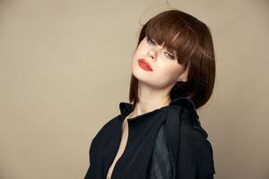 Pretty model black coat charming smile rejoicing studio photo