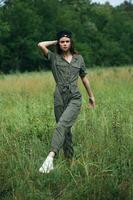 Woman on nature Walking green jumpsuit white sneakers photo