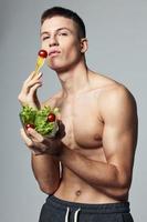 athletic man with bare shoulders bodybuilder lettuce energy diet photo