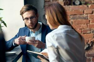 young couple work colleagues professional communication in a cafe photo