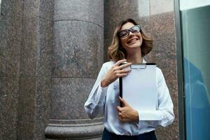 Business woman with documents on the street near the building photo