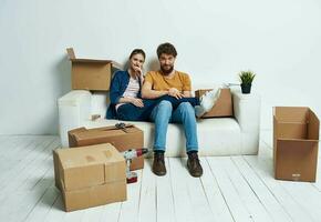 young married couple boxes with things moving room interior fun photo