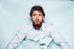 A man in a shirt peeks out from behind the wall of a career work emotions photo