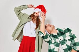 Man and woman in New Year's clothes Santa hat holiday fun emotions Friendship photo