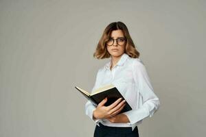 Business woman with notepad in hands professional office official photo