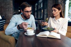 young couple in a cafe sitting at the table breakfast communication rest photo
