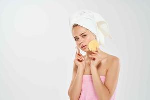 woman with towel cleans skin with sponge health problems hygiene photo