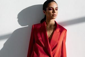 portrait of fashionable woman with evening makeup in red jacket photo