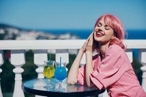 Young female drinking a cocktail on the terrace Happy female relaxing photo