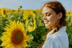 smiling woman in sunflower field nature sun agriculture photo