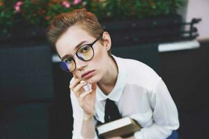 short haired woman with a book in his hands reading education photo