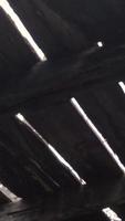 Light filters through cracks in wooden floor boards seen from below video