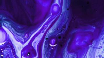 Blue and purple paint mixture flowing into each other video