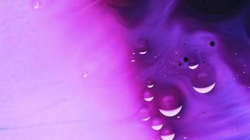 A combination of purple, blue, and pink frothy liquid flowing down video