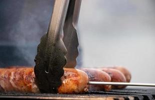 Barbequing sausages on the grill photo