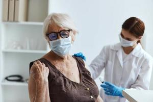 doctor with a syringe patient injection immunity protection covid passport close-up photo
