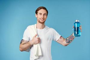 man in white t-shirt tattoos on his arms water bottle fitness lifestyle photo