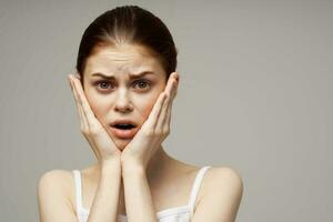 woman holding on to face pain in teeth studio treatment photo