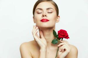 Woman with rose Eyes closed red lips luxury photo