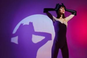 Portrait of a charming lady posing studio light neon color background unaltered photo